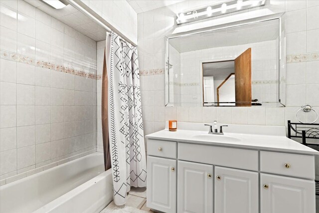 2865 Steeple Hill Rd, White Lake, MI 48383 - full bathroom featuring tile walls, vanity, shower / bath combo, decorative backsplash, and tile patterned flooring