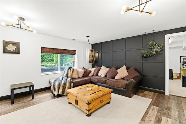 2865 Steeple Hill Rd, White Lake, MI 48383 - living room with a chandelier, wood finished floors, and a decorative wall