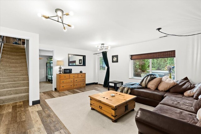 2865 Steeple Hill Rd, White Lake, MI 48383 - living area featuring a chandelier, wood finished floors, and stairway