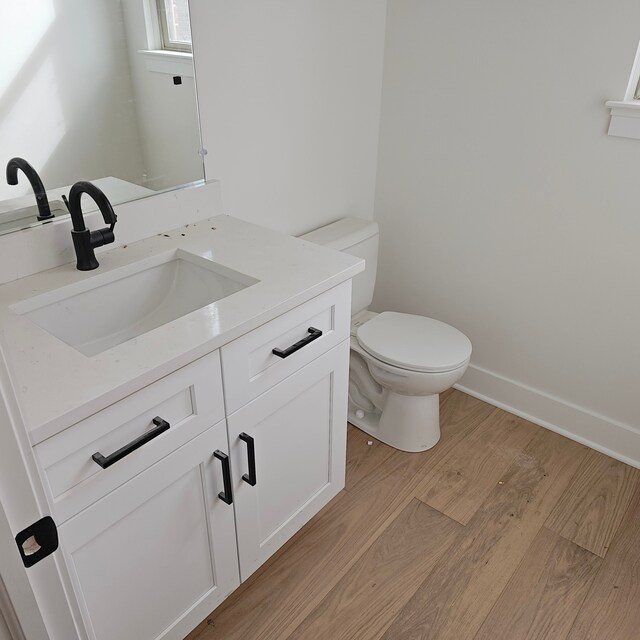 55834 Stewart Dr, Macomb, MI 48042 - half bath with wood finished floors, vanity, toilet, and baseboards