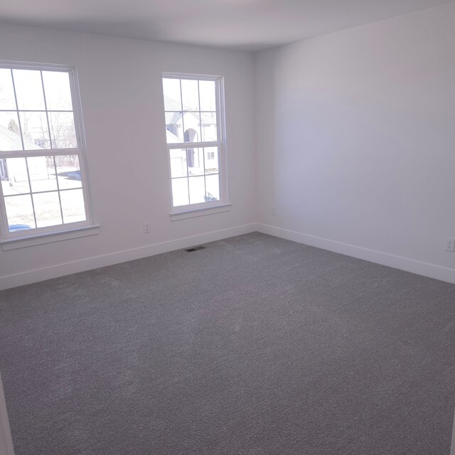 55834 Stewart Dr, Macomb, MI 48042 - empty room with baseboards and dark colored carpet
