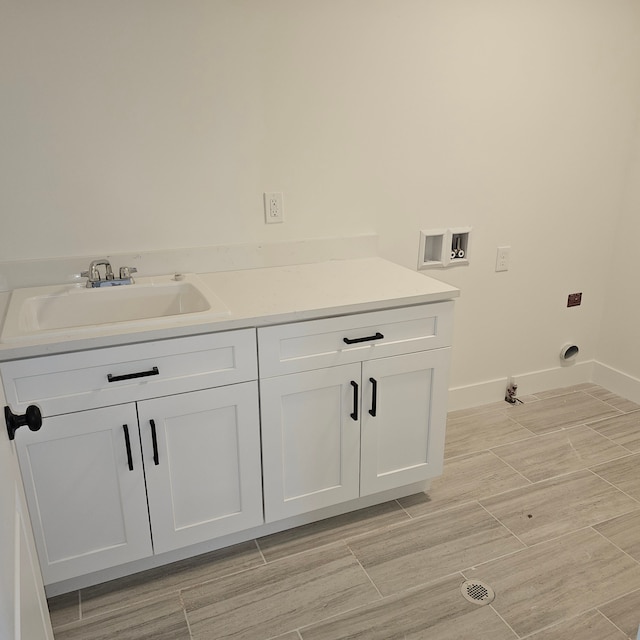 55834 Stewart Dr, Macomb, MI 48042 - laundry room featuring washer hookup, baseboards, cabinet space, and gas dryer hookup