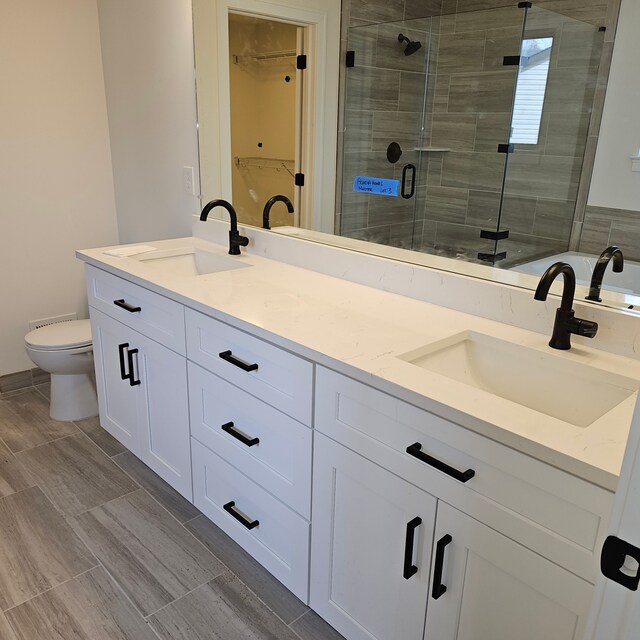 55834 Stewart Dr, Macomb, MI 48042 - full bath with double vanity, toilet, a shower stall, and a walk in closet