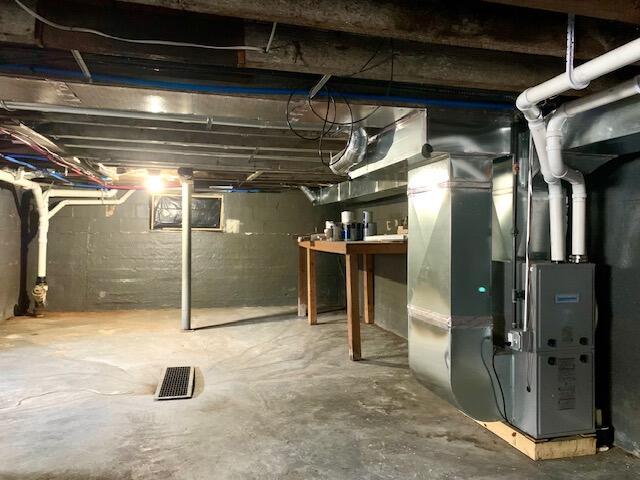 unfinished basement with heating unit