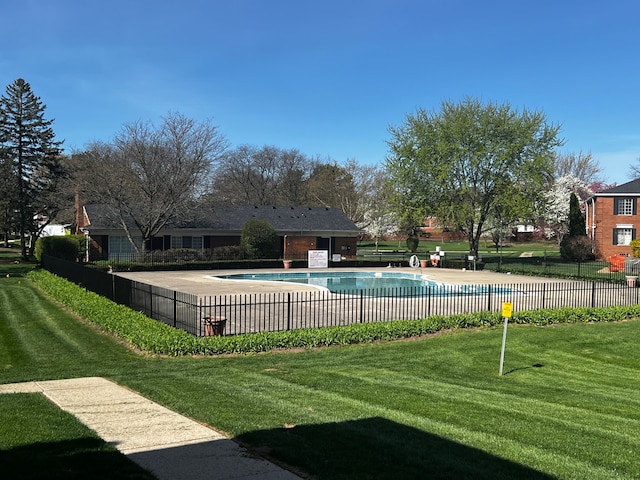pool with fence and a lawn