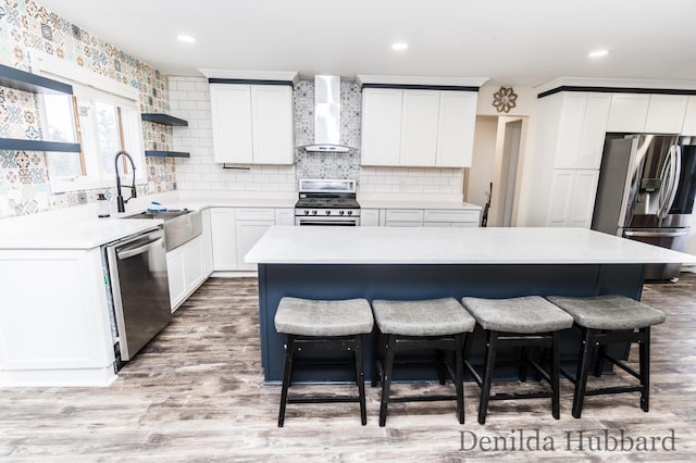11724 N Satterlee Rd, Lakeview, MI 48850 - kitchen with appliances with stainless steel finishes, wall chimney range hood, a breakfast bar, open shelves, and recessed lighting