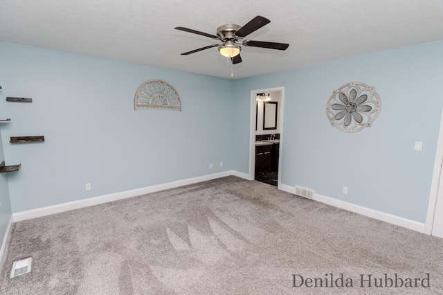 11724 N Satterlee Rd, Lakeview, MI 48850 - unfurnished bedroom with carpet, baseboards, ensuite bathroom, and a ceiling fan