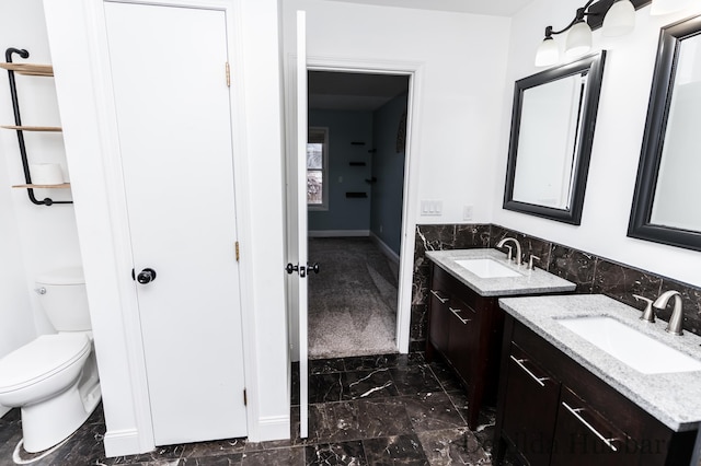 11724 N Satterlee Rd, Lakeview, MI 48850 - bathroom with marble look tile flooring, two vanities, and toilet