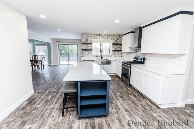 11724 N Satterlee Rd, Lakeview, MI 48850 - kitchen with open shelves, stainless steel gas range, wall chimney exhaust hood, a sink, and recessed lighting