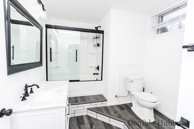 11724 N Satterlee Rd, Lakeview, MI 48850 - bathroom featuring a shower, toilet, vanity, wood finished floors, and baseboards