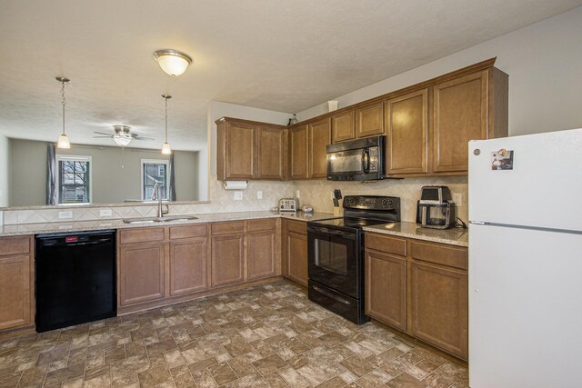 kitchen with decorative backsplash, black appliances, a sink, and brown cabinets