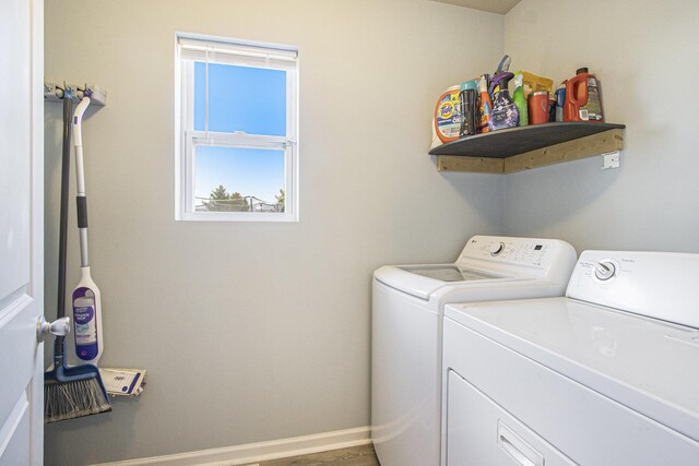 laundry area featuring washer and clothes dryer, laundry area, and baseboards