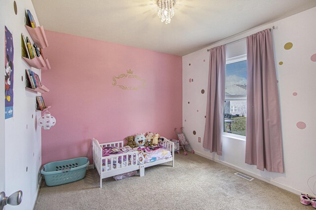 carpeted bedroom featuring baseboards and visible vents