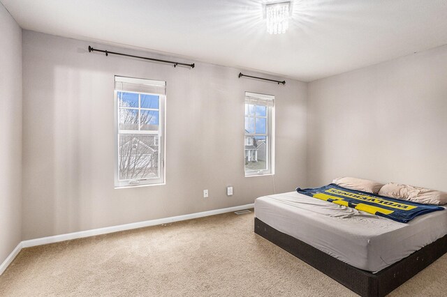 bedroom featuring carpet floors and baseboards