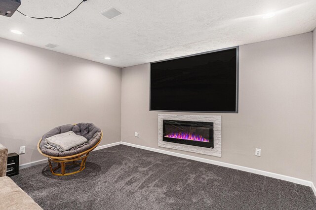 unfurnished room featuring carpet flooring, baseboards, and a textured ceiling