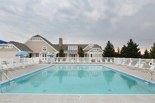 pool featuring fence and a patio