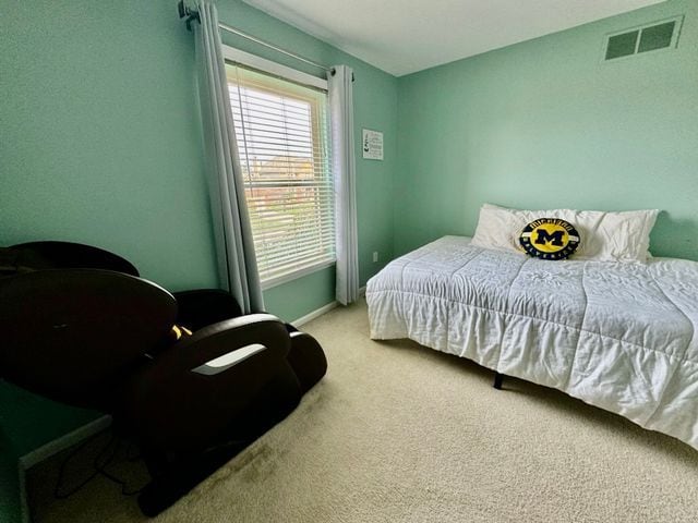 carpeted bedroom featuring baseboards and visible vents