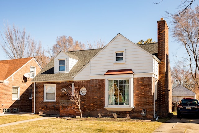 4494 Bishop St, Detroit, MI 48224 - view of front of home featuring brick siding, a chimney, a front yard, and roof with shingles