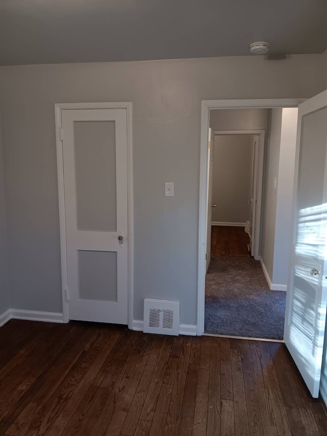 19726 Moross Rd, Detroit, MI 48224 - unfurnished room featuring dark wood-style flooring, baseboards, and visible vents