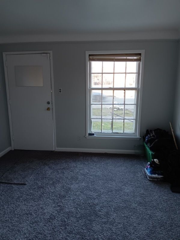 19726 Moross Rd, Detroit, MI 48224 - empty room featuring baseboards and dark carpet