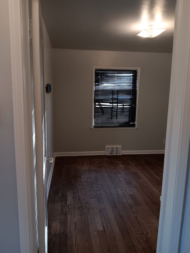19726 Moross Rd, Detroit, MI 48224 - unfurnished room with dark wood finished floors, baseboards, and visible vents