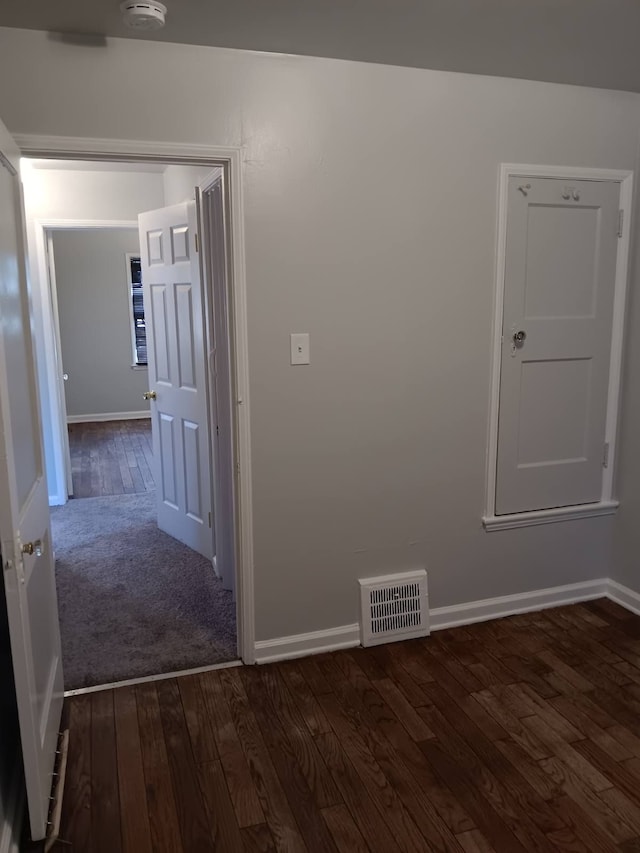 19726 Moross Rd, Detroit, MI 48224 - unfurnished room with baseboards, visible vents, and dark wood-style flooring