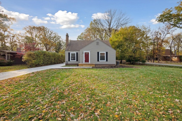 21124 Thorofare Rd, Grosse Ile, MI 48138 - bungalow with a front lawn, a chimney, and central AC unit