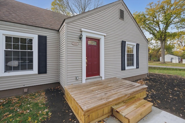 21124 Thorofare Rd, Grosse Ile, MI 48138 - view of exterior entry featuring roof with shingles