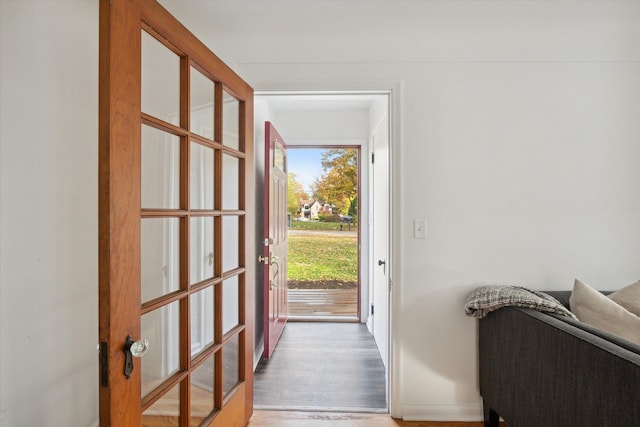 21124 Thorofare Rd, Grosse Ile, MI 48138 - doorway to outside featuring baseboards and light wood-style floors