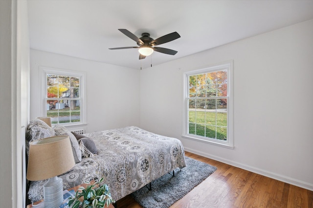 21124 Thorofare Rd, Grosse Ile, MI 48138 - bedroom with wood finished floors, baseboards, and ceiling fan