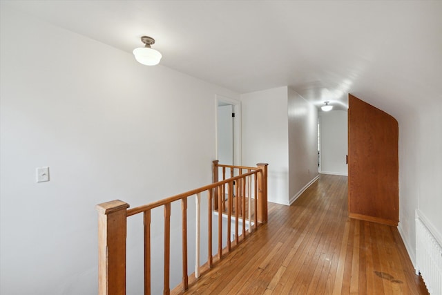 21124 Thorofare Rd, Grosse Ile, MI 48138 - hallway featuring baseboards, visible vents, light wood-style floors, and an upstairs landing