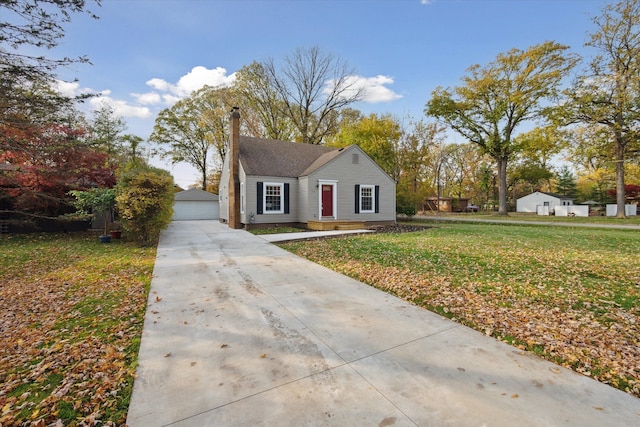 21124 Thorofare Rd, Grosse Ile, MI 48138 - view of front of property with a front lawn, a chimney, an outdoor structure, and a garage