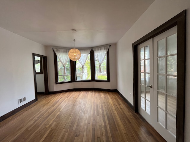 2563 Canton St, Detroit, MI 48207 - unfurnished dining area featuring baseboards, visible vents, french doors, and hardwood / wood-style flooring