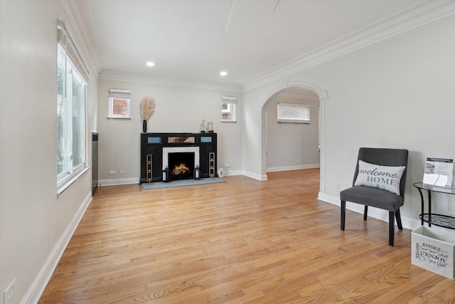 5784 Whittier St, Detroit, MI 48224 - living area with arched walkways, a wealth of natural light, light wood-style floors, and ornamental molding