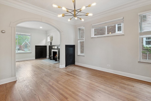 5784 Whittier St, Detroit, MI 48224 - unfurnished living room featuring crown molding, arched walkways, baseboards, and light wood-style floors
