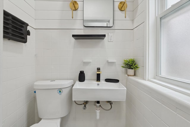 5784 Whittier St, Detroit, MI 48224 - bathroom with toilet, tile walls, a sink, and a healthy amount of sunlight