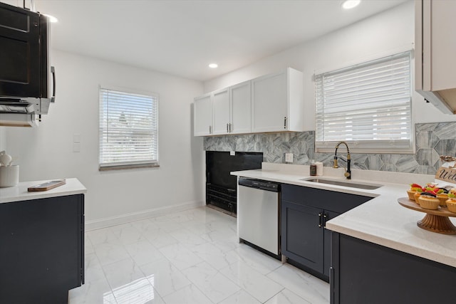 5784 Whittier St, Detroit, MI 48224 - kitchen featuring decorative backsplash, light countertops, marble finish floor, dishwasher, and a sink