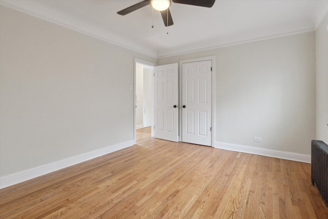 5784 Whittier St, Detroit, MI 48224 - unfurnished bedroom with light wood-style flooring, ceiling fan, baseboards, radiator, and ornamental molding