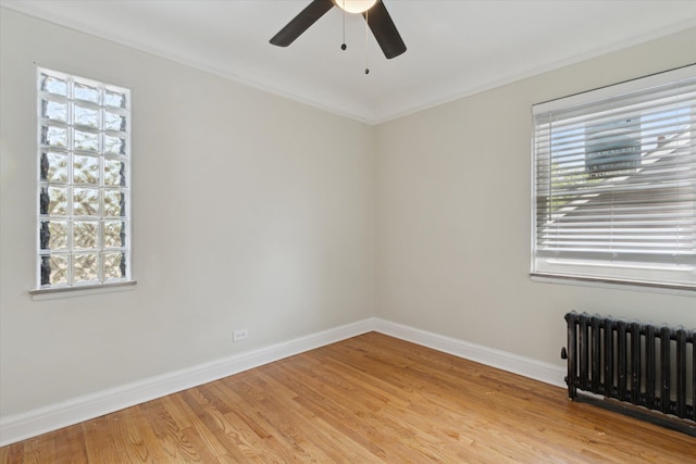 5784 Whittier St, Detroit, MI 48224 - empty room featuring light wood-style floors, radiator, baseboards, a ceiling fan, and crown molding