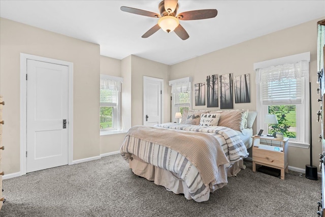 3440 Crandall Rd, Howell, MI 48855 - carpeted bedroom featuring baseboards, multiple windows, and a ceiling fan