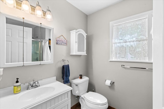3440 Crandall Rd, Howell, MI 48855 - bathroom with toilet, vanity, baseboards, and a shower