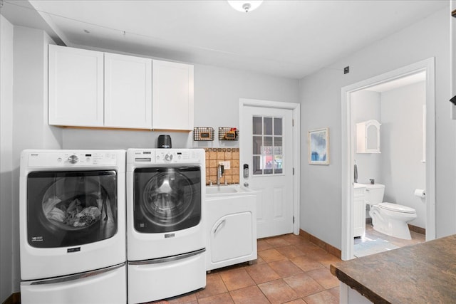 3440 Crandall Rd, Howell, MI 48855 - washroom featuring separate washer and dryer, cabinet space, and baseboards