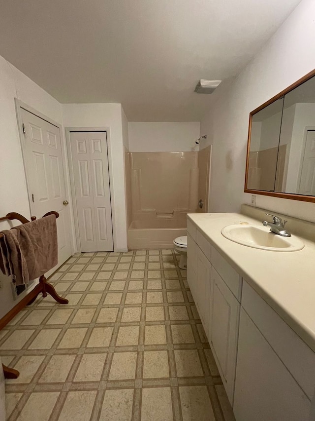 full bathroom with toilet, tile patterned floors, washtub / shower combination, and vanity