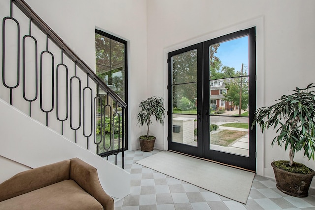 557 Greenwood Ave SE, East Grand Rapids, MI 49506 - entrance foyer with light floors, stairway, and french doors