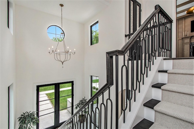 557 Greenwood Ave SE, East Grand Rapids, MI 49506 - stairway featuring an inviting chandelier and a high ceiling