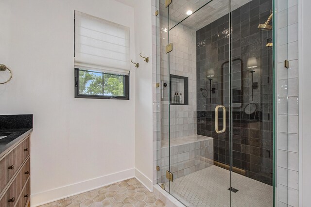 557 Greenwood Ave SE, East Grand Rapids, MI 49506 - bathroom featuring tile patterned flooring, vanity, a stall shower, and baseboards