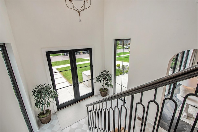 557 Greenwood Ave SE, East Grand Rapids, MI 49506 - entrance foyer featuring tile patterned floors, a high ceiling, and french doors