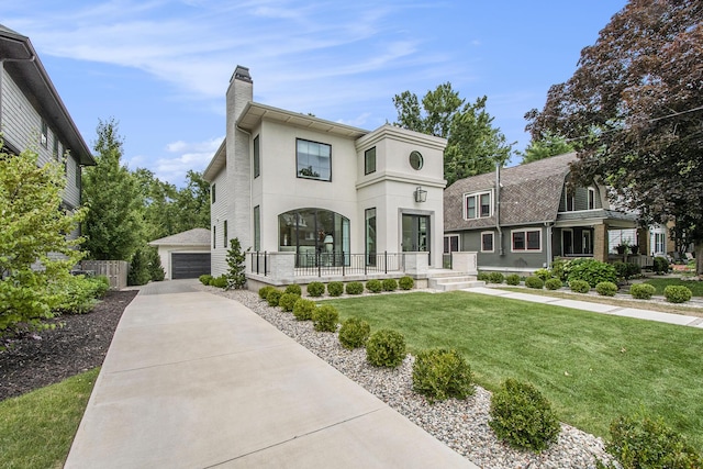 557 Greenwood Ave SE, East Grand Rapids, MI 49506 - view of front of house with an outdoor structure, a front yard, covered porch, a garage, and a chimney