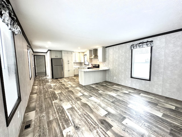 3502 Beech Ln, Twin Lake, MI 49457 - unfurnished living room featuring wood finished floors and crown molding