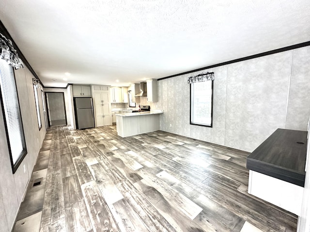 3502 Beech Ln, Twin Lake, MI 49457 - unfurnished living room featuring light wood-style flooring and crown molding